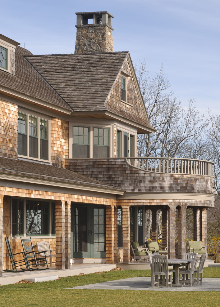 This is an example of a large traditional three-storey exterior in Boston with wood siding.