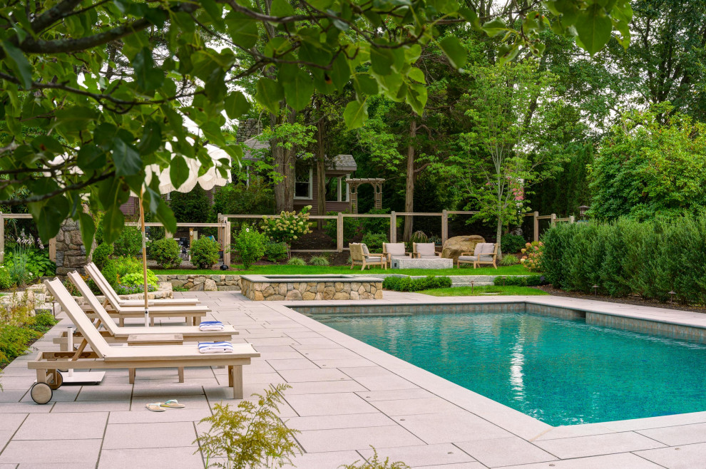 Modelo de piscinas y jacuzzis contemporáneos rectangulares en patio trasero con suelo de baldosas