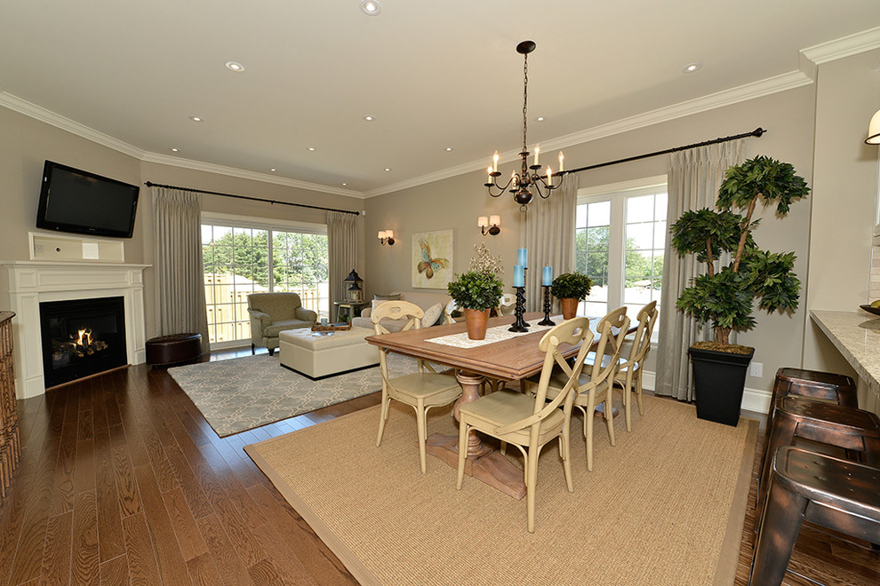 Mid-sized transitional l-shaped medium tone wood floor open concept kitchen photo in Toronto with a double-bowl sink, recessed-panel cabinets, white cabinets, granite countertops, beige backsplash, stone tile backsplash, stainless steel appliances and a peninsula