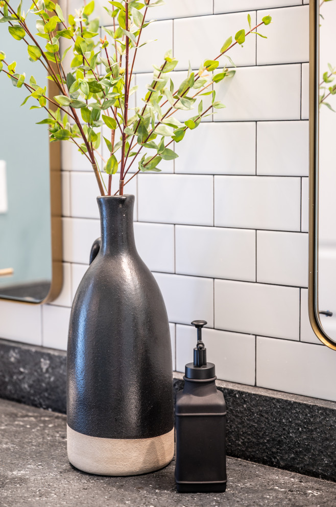 Example of a mid-sized transitional white tile and subway tile ceramic tile, multicolored floor and single-sink drop-in bathtub design in Little Rock with shaker cabinets, beige cabinets, a two-piece toilet, green walls, an undermount sink, granite countertops, black countertops and a built-in vanity