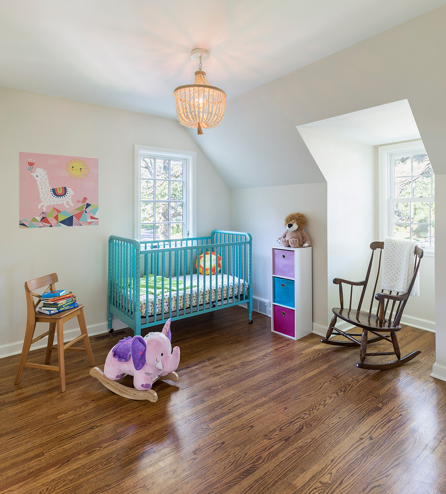 Inspiration for a mid-sized eclectic gender-neutral nursery in Minneapolis with medium hardwood floors and white walls.