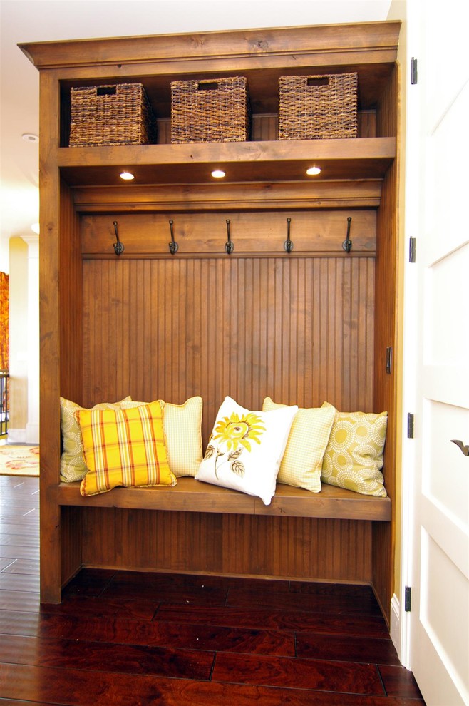 This is an example of a traditional mudroom in Austin with medium hardwood floors and a white front door.