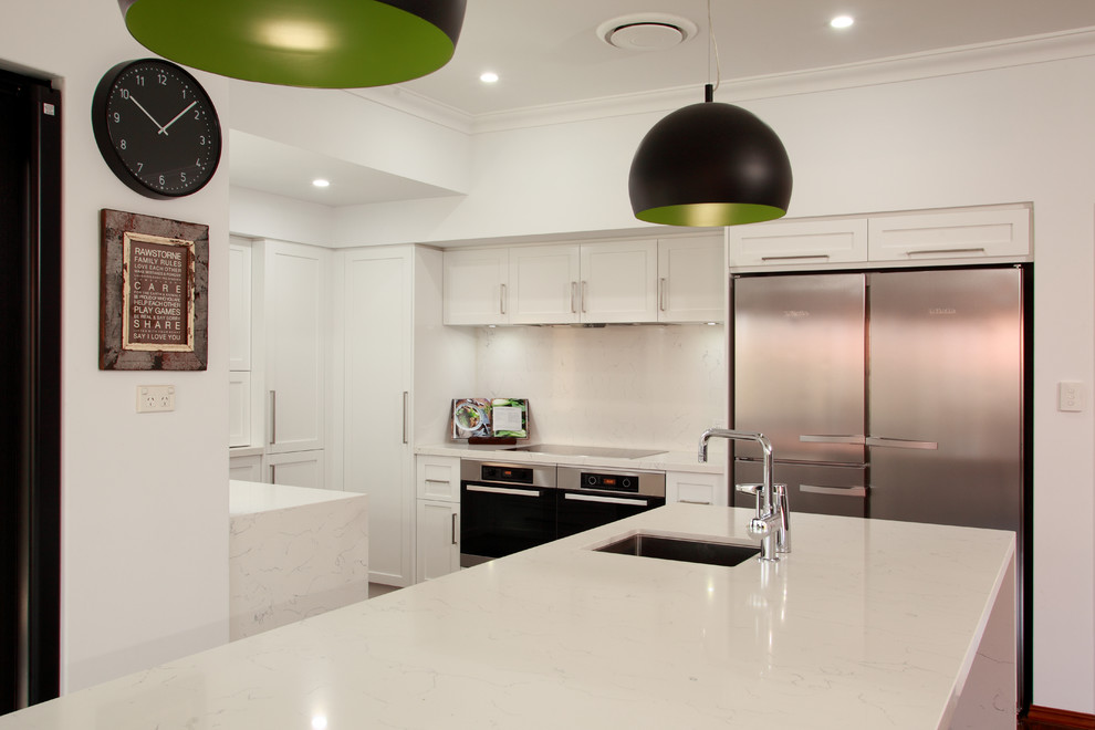 Inspiration for a mid-sized transitional eat-in kitchen in Perth with an undermount sink, shaker cabinets, white cabinets, quartz benchtops, white splashback, stone slab splashback, stainless steel appliances, bamboo floors and with island.