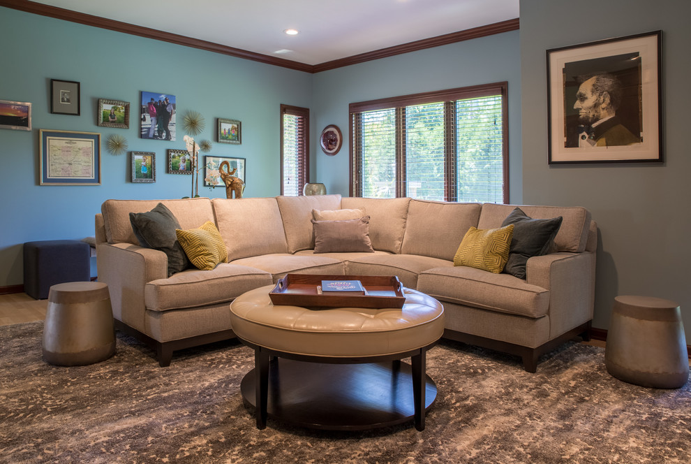 This is an example of a contemporary enclosed family room in Cedar Rapids with blue walls, medium hardwood floors and brown floor.