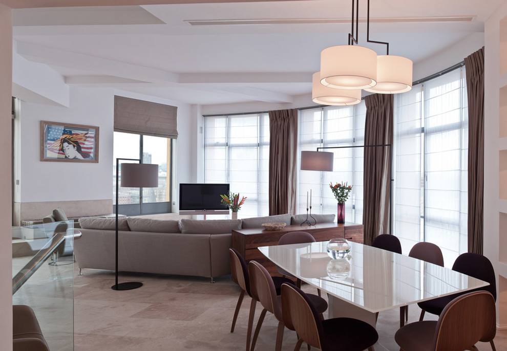 This is an example of a contemporary dining room in London with white walls and marble floors.