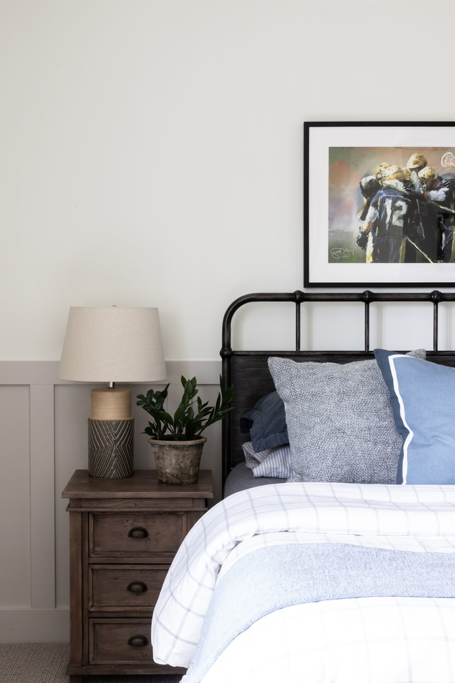 Derby House Kids Wing - Newly remodeled boys bedroom with new batten board wainscoting, closet doors, trim, paint, lighting, and new loop wall to wall carpet. Queen bed with windowpane plaid duvet. Photo by Emily Kennedy Photography.