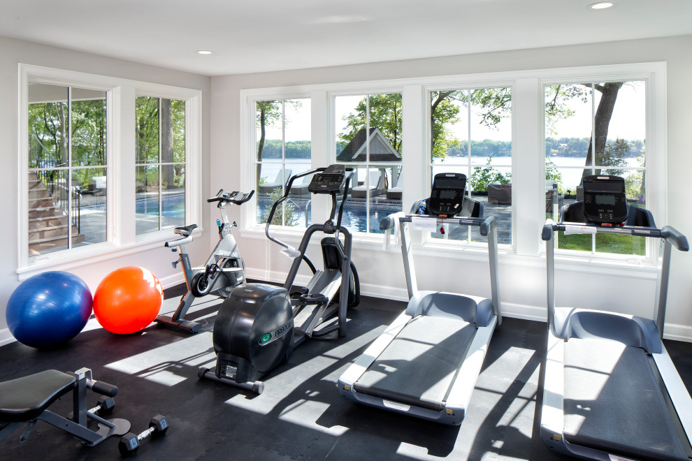 This is an example of a mid-sized transitional home weight room in Minneapolis with white walls and black floor.