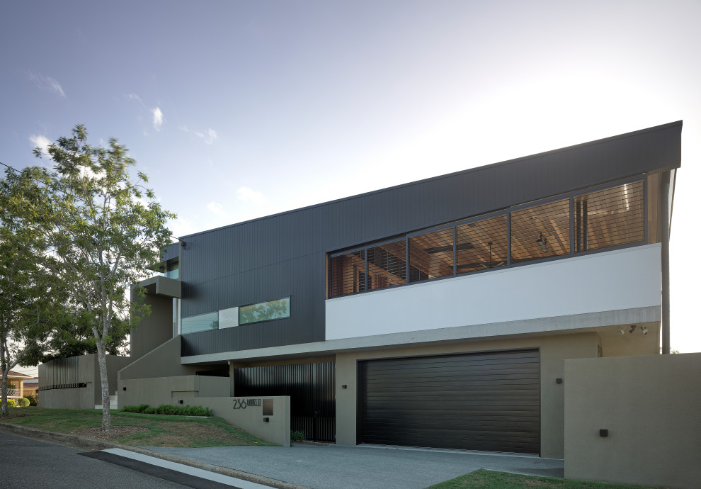 Design ideas for a contemporary two-storey multi-coloured house exterior in Brisbane with mixed siding and a shed roof.