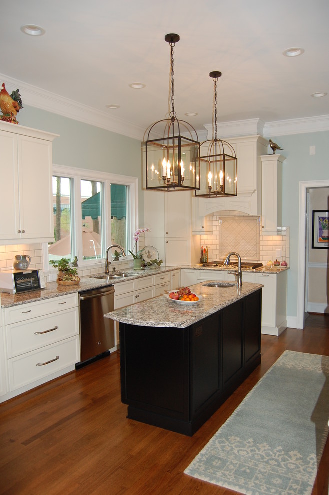 Example of a transitional u-shaped eat-in kitchen design in Raleigh with an undermount sink, recessed-panel cabinets, white cabinets, quartzite countertops, white backsplash, subway tile backsplash and stainless steel appliances