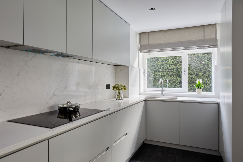 Inspiration for a medium sized modern grey and white u-shaped enclosed kitchen in London with a submerged sink, flat-panel cabinets, grey cabinets, marble worktops, grey splashback, marble splashback, integrated appliances, dark hardwood flooring, no island, black floors and grey worktops.