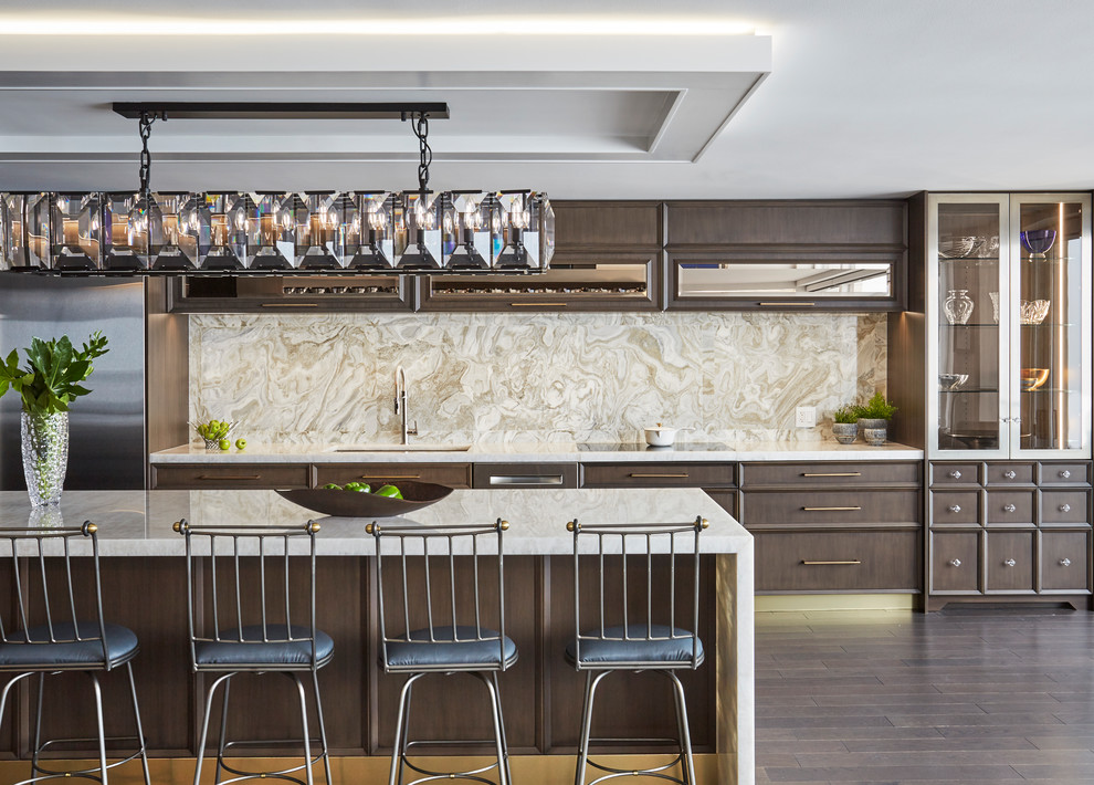 Transitional galley dark wood floor and brown floor eat-in kitchen photo in Chicago with an undermount sink, dark wood cabinets, beige backsplash, stainless steel appliances, an island and beige countertops