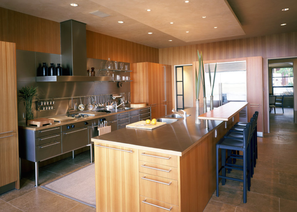 This is an example of a large contemporary galley eat-in kitchen in Austin with an integrated sink, flat-panel cabinets, beige cabinets, concrete benchtops, metallic splashback, metal splashback, stainless steel appliances, terra-cotta floors, with island and multi-coloured floor.