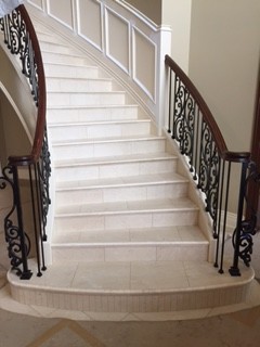 Inspiration for a mid-sized transitional tile curved metal railing staircase remodel with tile risers