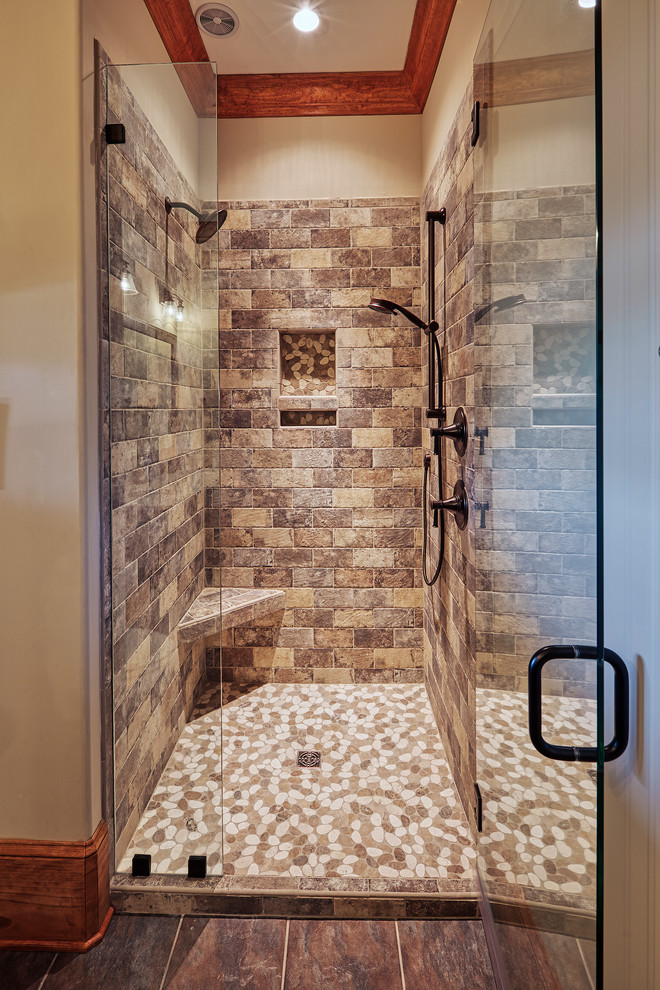 Photo of a mid-sized country 3/4 bathroom with shaker cabinets, medium wood cabinets, an alcove shower, a one-piece toilet, beige tile, white walls, an undermount sink, white floor, a hinged shower door and beige benchtops.