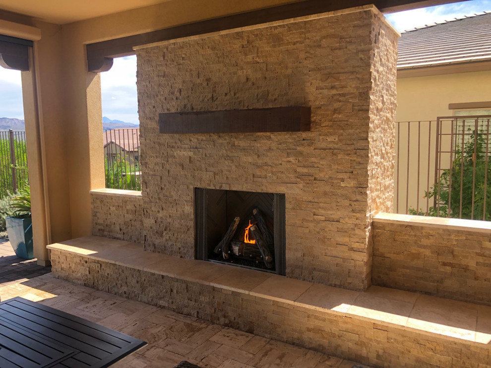 Large transitional backyard stone patio photo in Phoenix with a fireplace and a roof extension