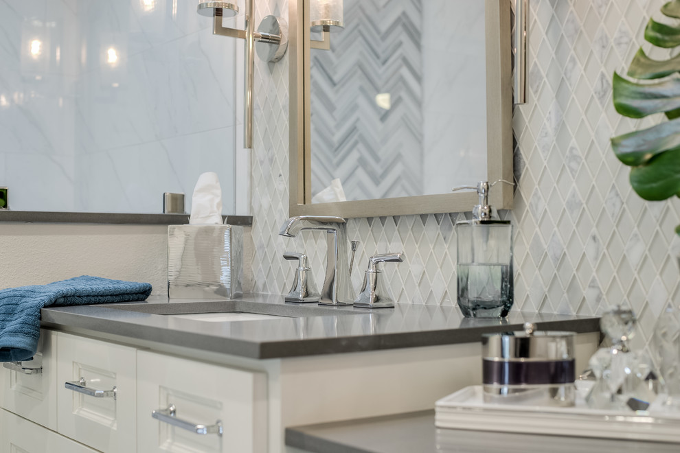 Inspiration for a small transitional master bathroom in Dallas with shaker cabinets, white cabinets, a corner shower, a two-piece toilet, white tile, marble, grey walls, porcelain floors, an undermount sink, engineered quartz benchtops, grey floor and a hinged shower door.