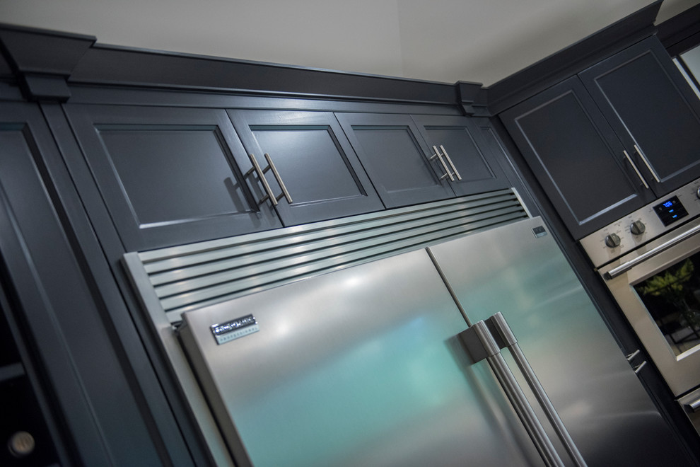 Example of a large transitional u-shaped dark wood floor kitchen design with an undermount sink, beaded inset cabinets, gray cabinets, quartz countertops, white backsplash, subway tile backsplash, stainless steel appliances and an island