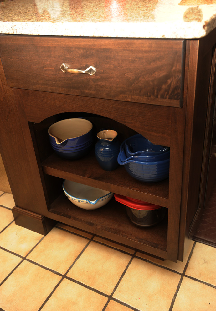 Eat-in kitchen - mid-sized transitional l-shaped ceramic tile eat-in kitchen idea with an undermount sink, recessed-panel cabinets, dark wood cabinets, granite countertops, multicolored backsplash, glass tile backsplash, stainless steel appliances and an island