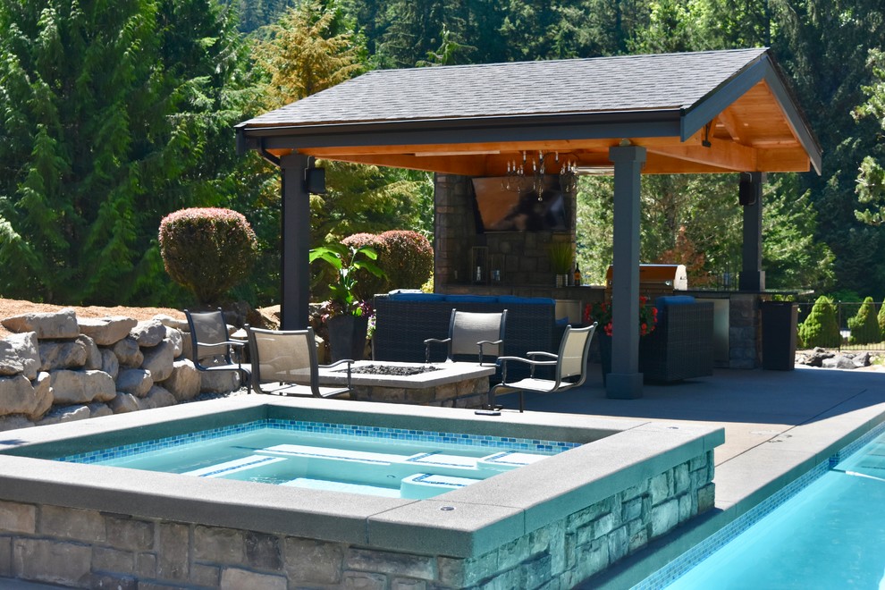Inspiration for a large arts and crafts backyard rectangular lap pool in Seattle with a hot tub and concrete slab.