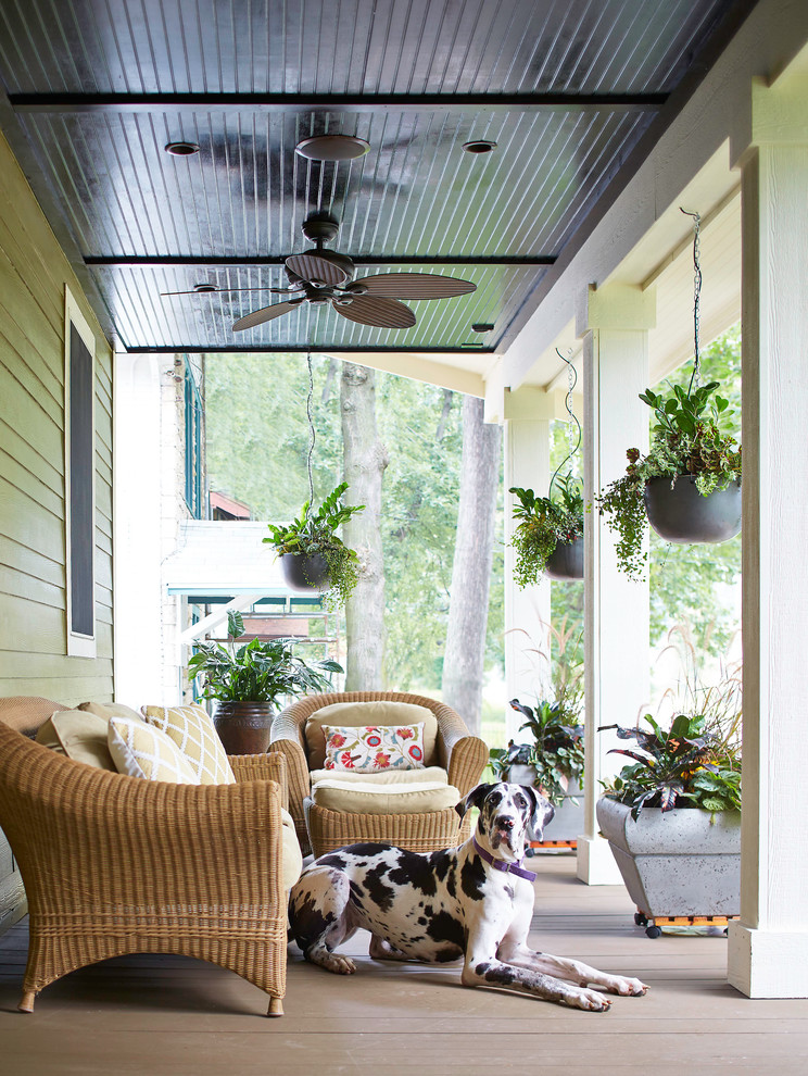 This is an example of a mid-sized craftsman front porch design in Other with decking and a roof extension.