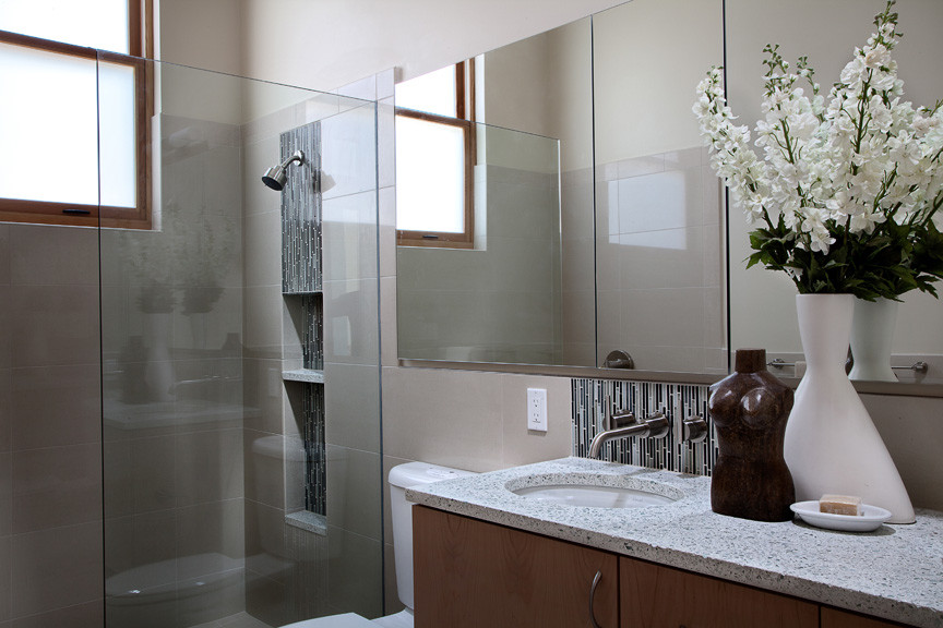 Mid-sized contemporary master bathroom in Seattle with an undermount sink, flat-panel cabinets, light wood cabinets, recycled glass benchtops, an open shower, a two-piece toilet, beige tile, ceramic tile, beige walls and ceramic floors.