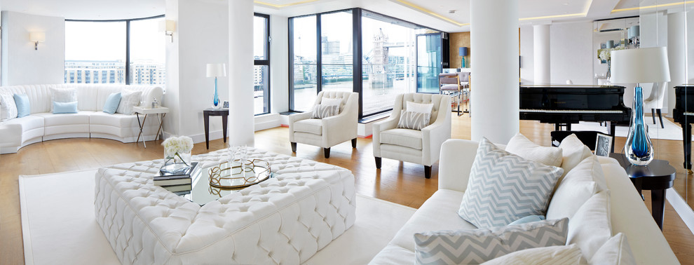 Contemporary formal open concept living room in London with a wall-mounted tv.