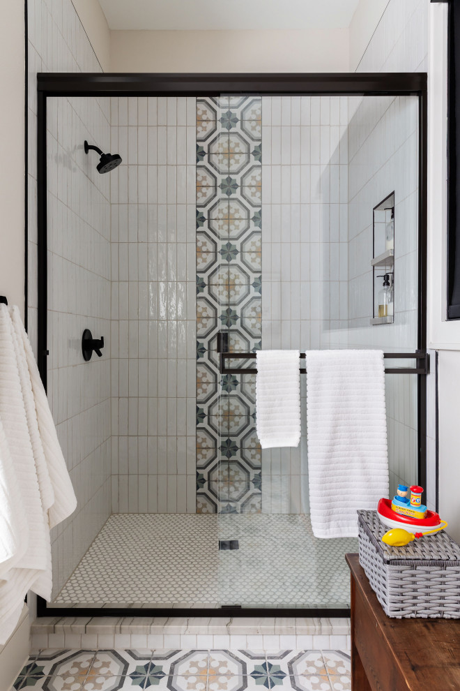 Bathroom - mid-sized transitional kids' white tile and ceramic tile porcelain tile, multicolored floor and double-sink bathroom idea in Dallas with recessed-panel cabinets, green cabinets, a one-piece toilet, white walls, an undermount sink, quartzite countertops, gray countertops and a freestanding vanity