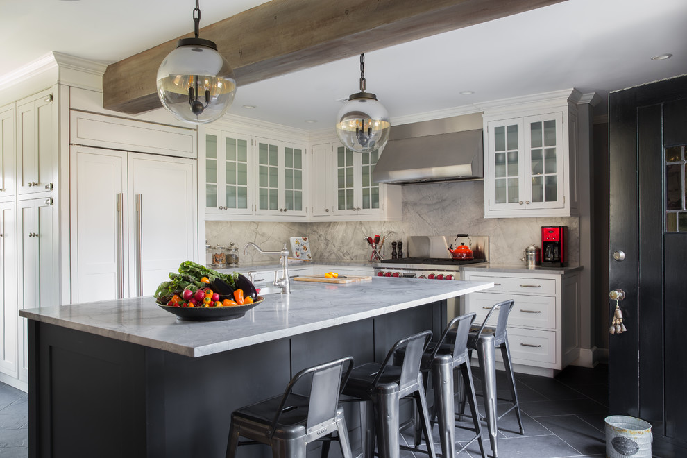 Inspiration for a mid-sized transitional l-shaped slate floor and gray floor kitchen remodel in New York with white cabinets, quartzite countertops, gray backsplash, stone slab backsplash, an island, an undermount sink, glass-front cabinets and paneled appliances