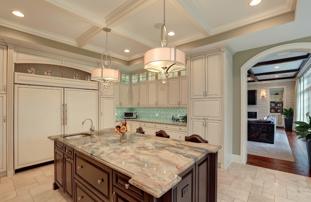 Photo of a large traditional u-shaped eat-in kitchen in Chicago with an undermount sink, raised-panel cabinets, white cabinets, granite benchtops, green splashback, ceramic splashback, panelled appliances, ceramic floors and with island.