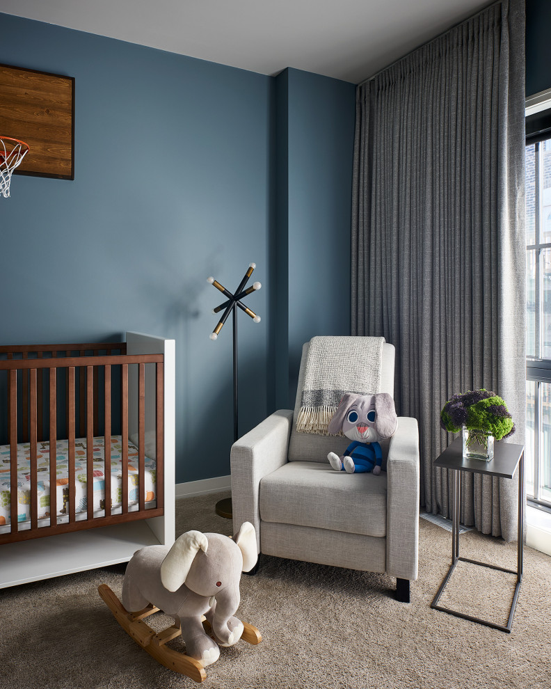 Inspiration for a mid-sized contemporary nursery for boys in Chicago with blue walls, carpet and brown floor.