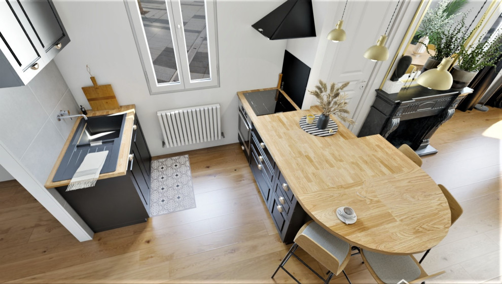 Mid-sized industrial galley eat-in kitchen in Toulouse with an undermount sink, black cabinets, wood benchtops, black splashback, marble splashback, light hardwood floors and with island.