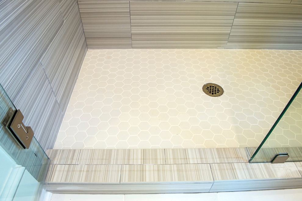 Inspiration for a traditional bathroom in Atlanta with blue cabinets, beige tile, porcelain tile, beige walls, porcelain floors and a drop-in sink.