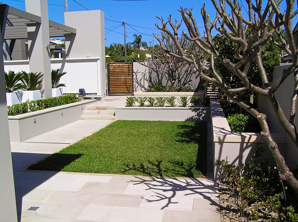 This is an example of a mid-sized beach style courtyard patio in Sydney with an outdoor shower and decking.