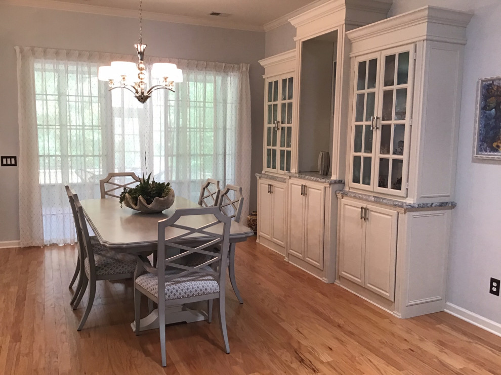 Photo of a mid-sized transitional open plan dining in Other with blue walls, light hardwood floors, no fireplace and beige floor.