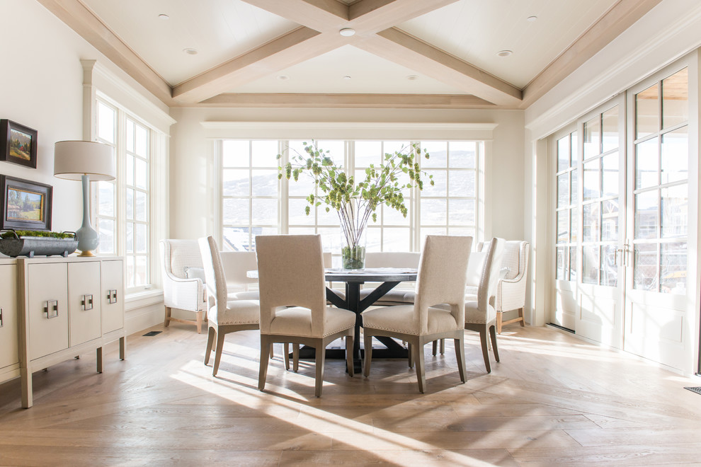 This is an example of a mid-sized traditional open plan dining in Salt Lake City with white walls, light hardwood floors, no fireplace and beige floor.