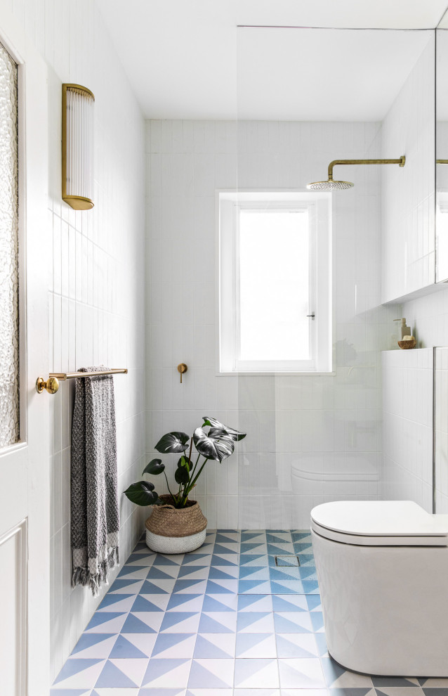 Inspiration for a small contemporary master bathroom in Sydney with an open shower, a two-piece toilet, white tile, ceramic tile, white walls, porcelain floors, a wall-mount sink, blue floor, a niche, a single vanity and a floating vanity.