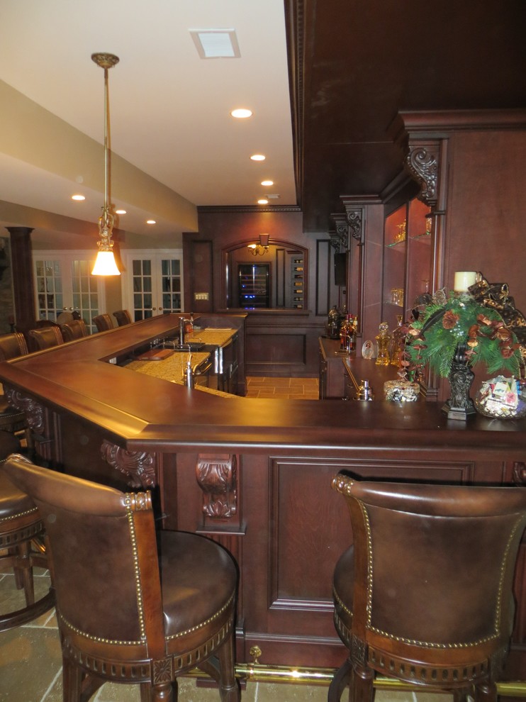Design ideas for a large traditional single-wall seated home bar in Newark with beaded inset cabinets, dark wood cabinets, carpet, wood benchtops and brown floor.