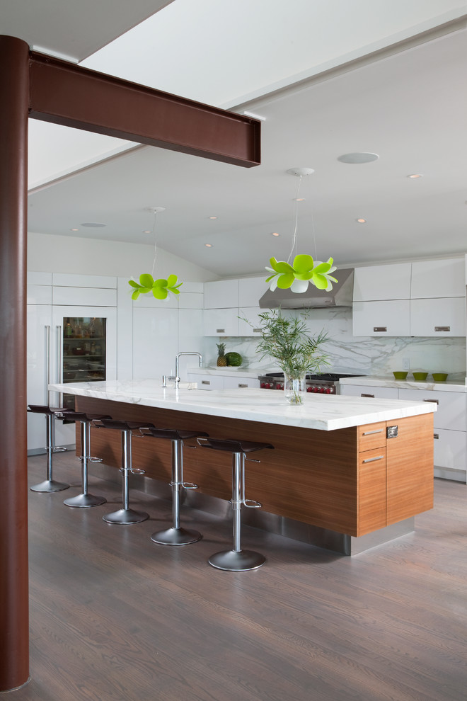 Photo of a contemporary kitchen in Wilmington with flat-panel cabinets, white cabinets and white appliances.