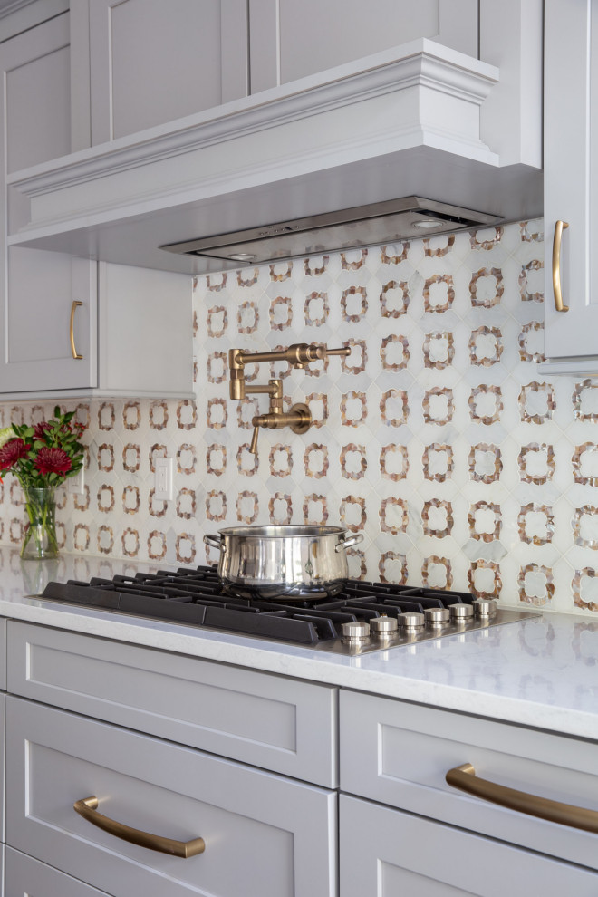 Transitional dark wood floor and brown floor kitchen photo with a drop-in sink, shaker cabinets, gray cabinets, quartzite countertops, white backsplash, mosaic tile backsplash, stainless steel appliances, an island and white countertops