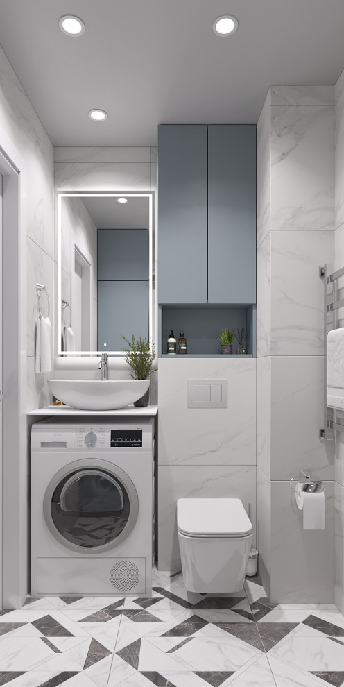 Foto på ett litet funkis vit badrum med dusch, med blå skåp, en vägghängd toalettstol, vit kakel, marmorkakel, klinkergolv i keramik, ett nedsänkt handfat, bänkskiva i akrylsten och dusch med gångjärnsdörr