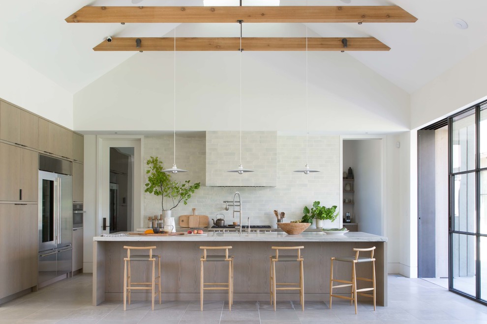 Country kitchen in San Francisco with flat-panel cabinets, light wood cabinets, stainless steel appliances, with island, grey floor and grey benchtop.