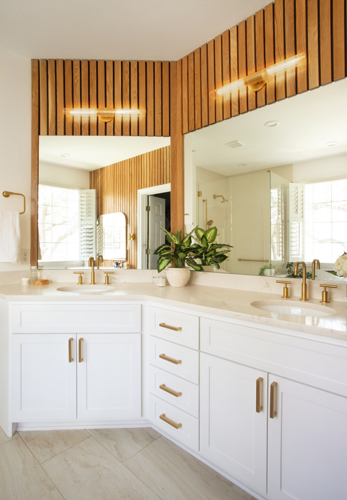 Inspiration for a mid-sized midcentury master bathroom in Austin with white cabinets, marble benchtops, beige floor, beige benchtops, a double vanity, a built-in vanity and wood walls.