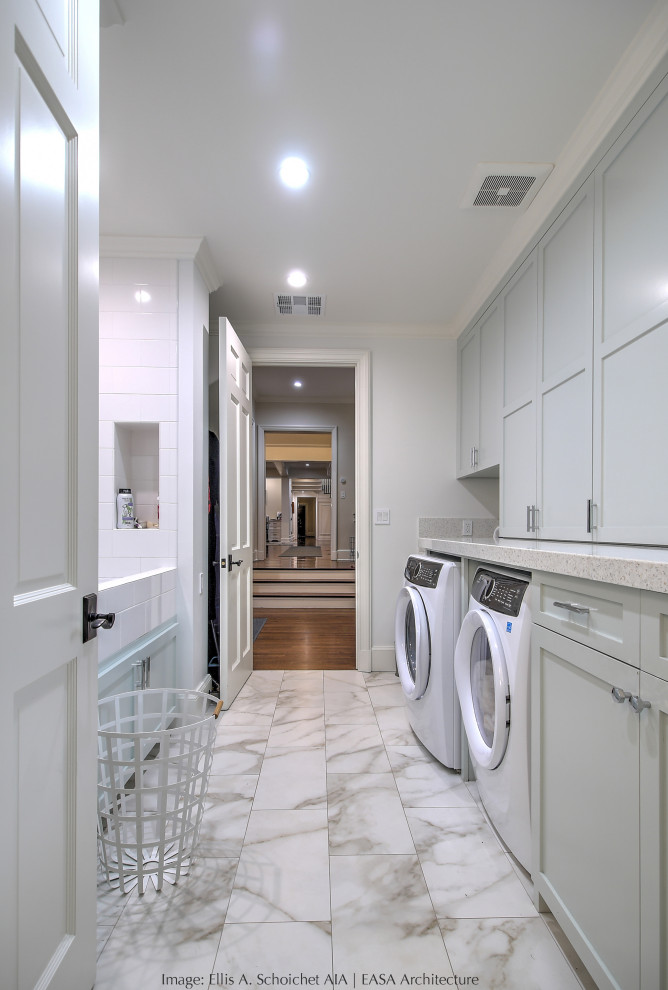 Inspiration for a large transitional galley utility room in San Francisco with an integrated sink, recessed-panel cabinets, grey cabinets, beige splashback, white walls, a side-by-side washer and dryer, white floor, beige benchtop, porcelain floors and terrazzo benchtops.