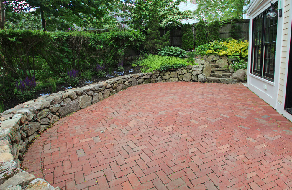 Mid-sized traditional backyard patio in Boston with brick pavers and no cover.