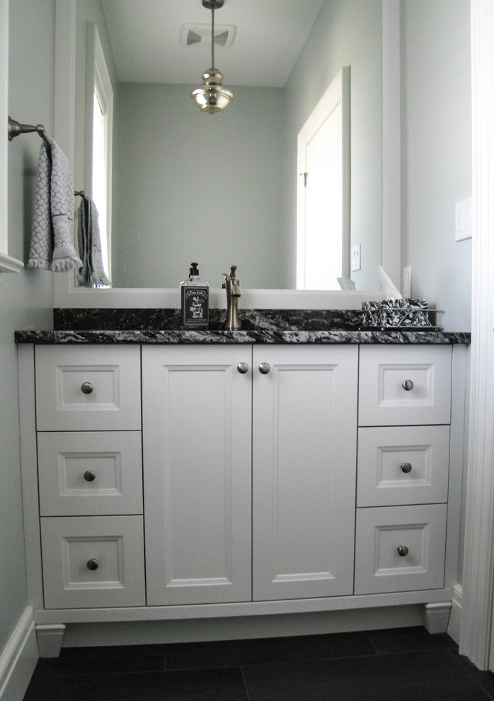 Transitional bathroom photo in Toronto with white cabinets, an undermount sink and granite countertops