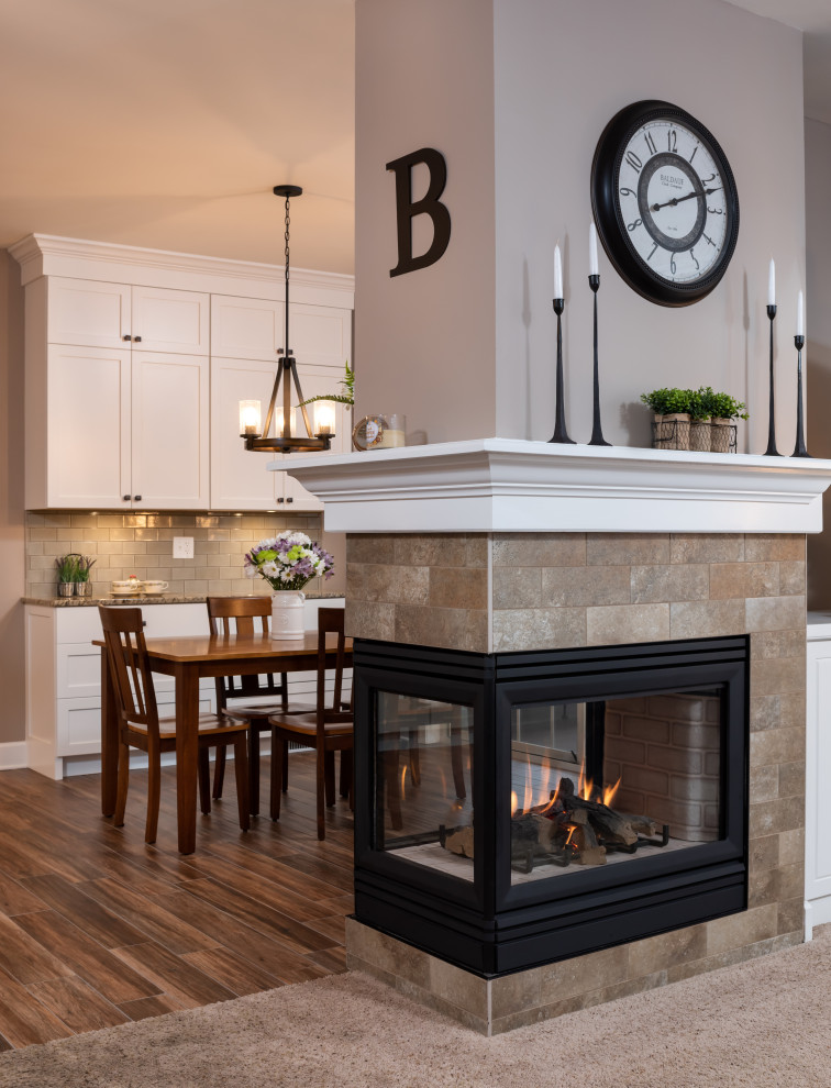 Inspiration for a mid-sized transitional galley open concept kitchen remodel with an undermount sink, shaker cabinets, white cabinets, granite countertops, green backsplash, subway tile backsplash, stainless steel appliances, an island and multicolored countertops