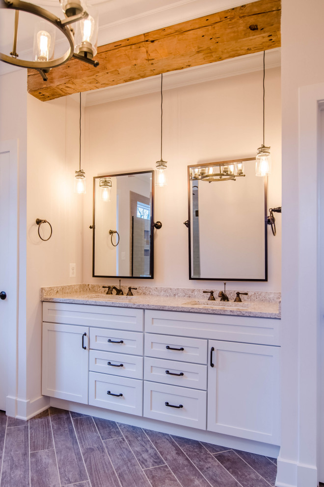 Photo of a country master bathroom in Baltimore with white cabinets, a freestanding tub, a double vanity, a built-in vanity and exposed beam.