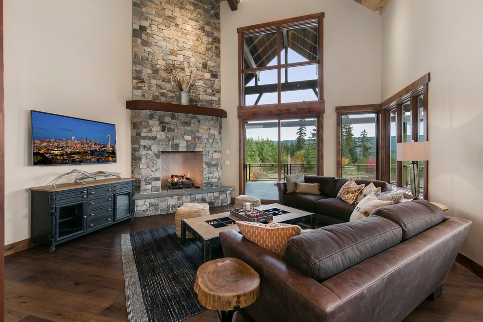 Country open concept family room in Seattle with white walls, dark hardwood floors, a standard fireplace, a stone fireplace surround, a wall-mounted tv and brown floor.