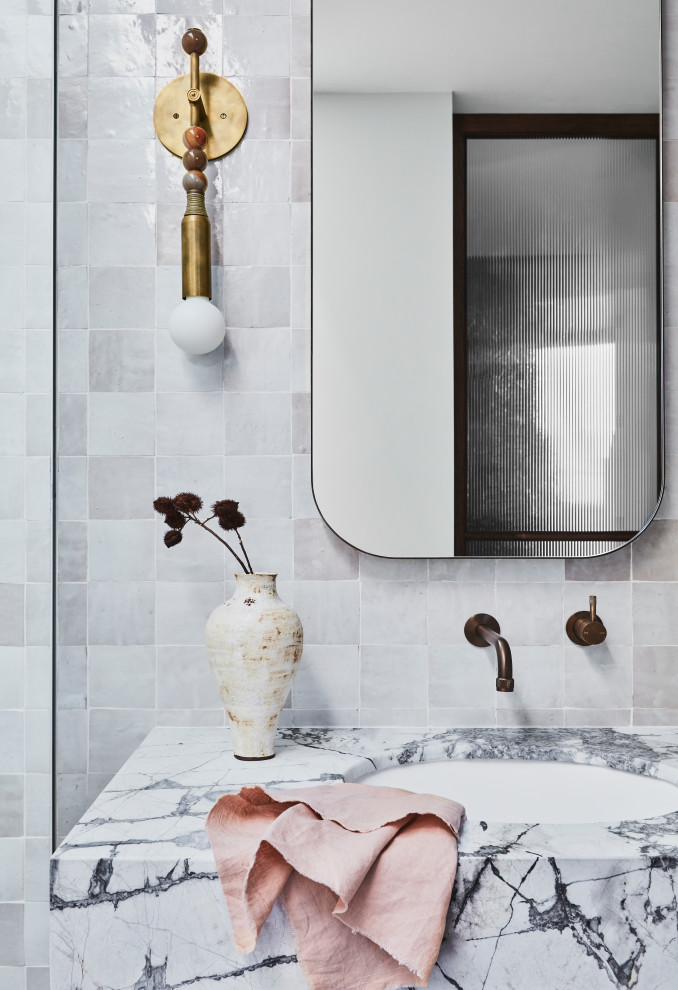 Large trendy master beige tile and porcelain tile ceramic tile, multicolored floor and double-sink bathroom photo in Sydney with louvered cabinets, brown cabinets, white walls, an integrated sink, marble countertops, gray countertops and a floating vanity