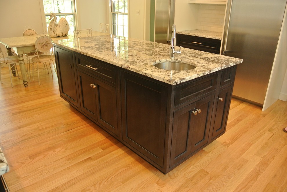 Transitional light wood floor eat-in kitchen photo in Boston with an undermount sink, shaker cabinets, granite countertops, white backsplash, subway tile backsplash, stainless steel appliances and an island